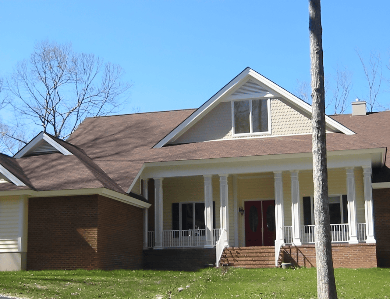 Two-story home with brown roof